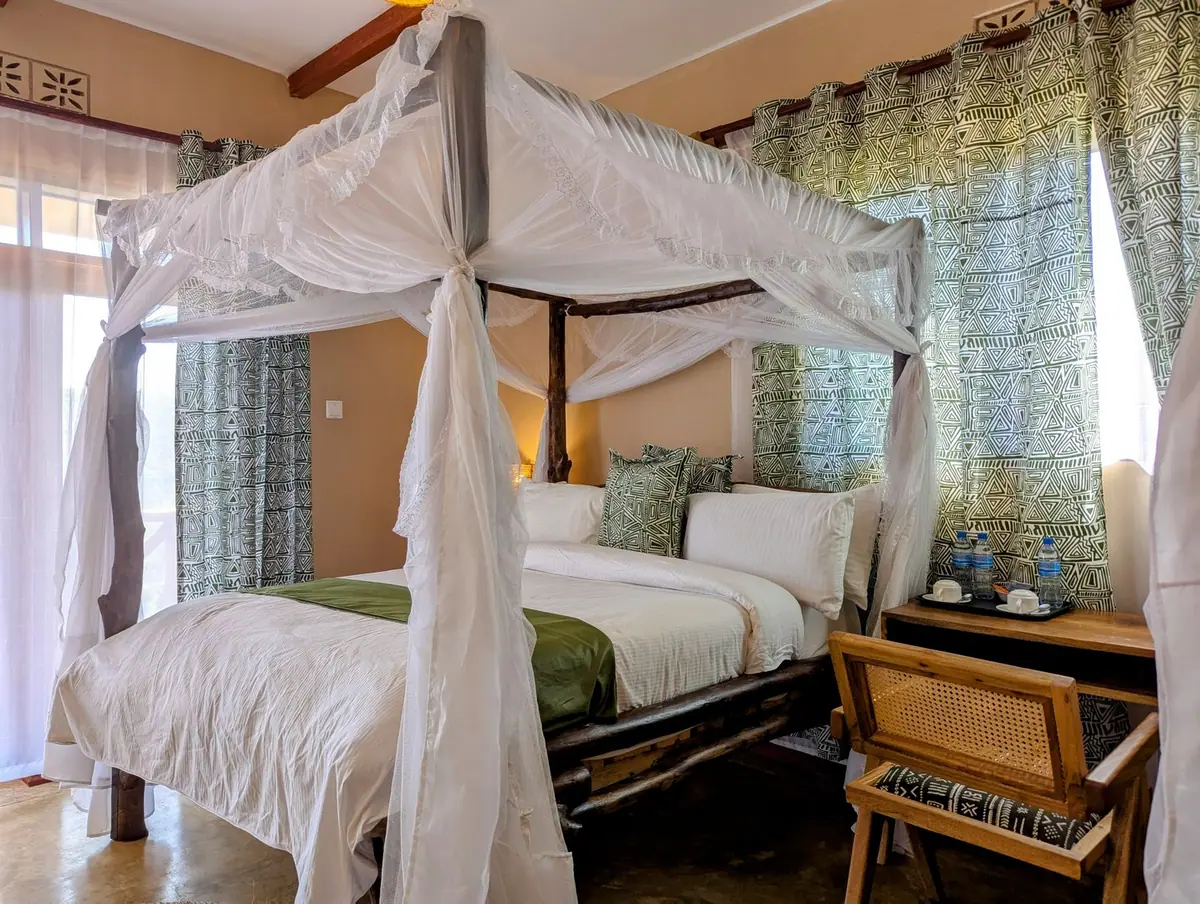 Four-poster beds in a room at Mvuli Mountain Lodge