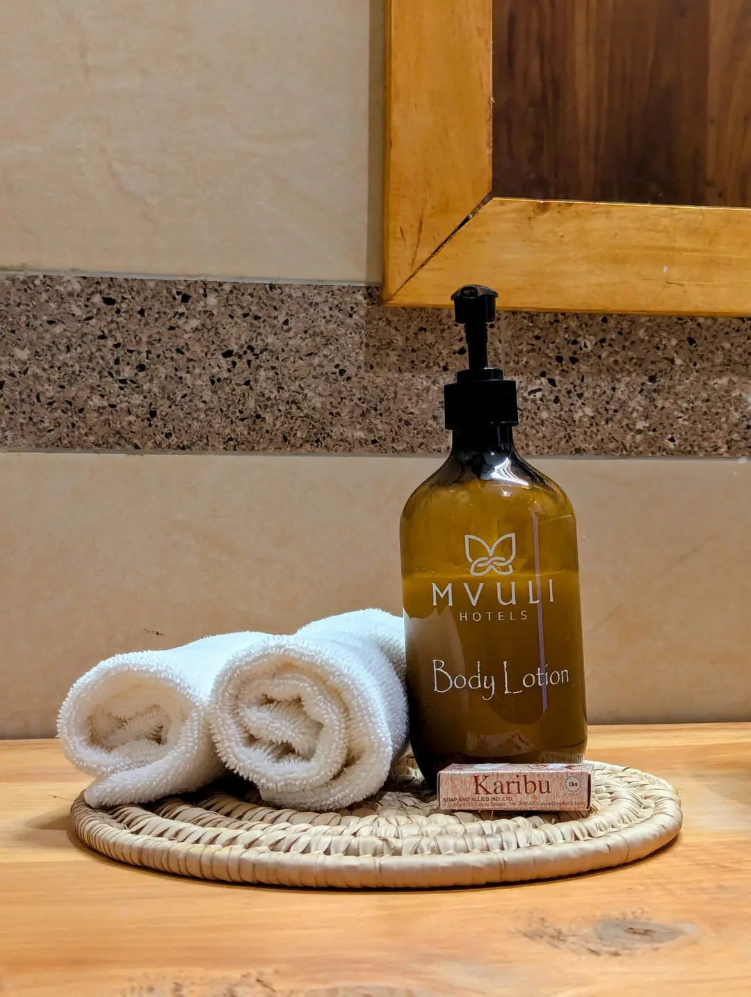 Mvuli body lotion and rolled towels