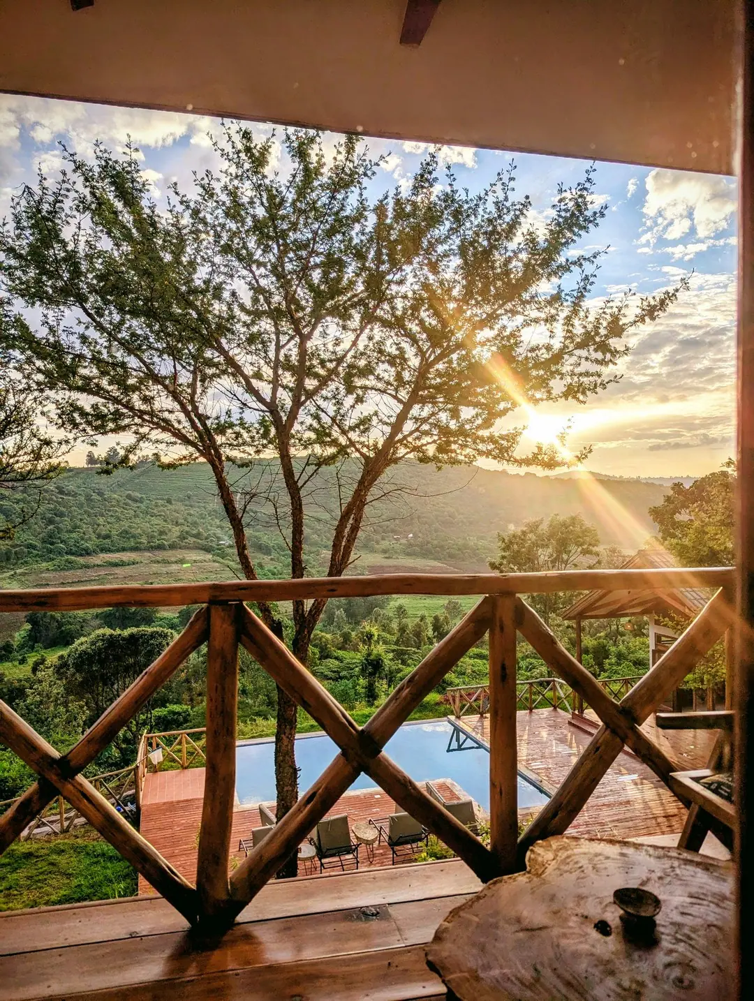 Sunrise over the highland forest from a balcony, Mvuli Mountain Lodge