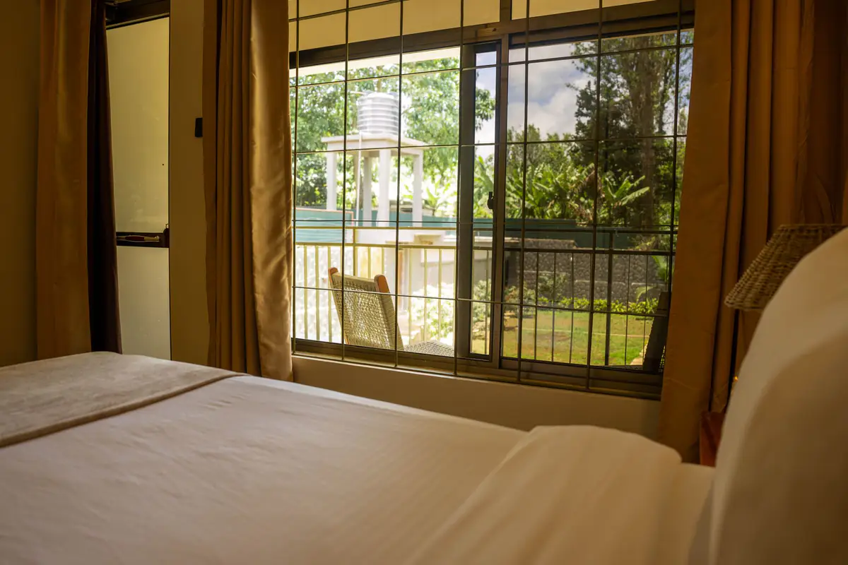 Garden view from a bedroom window at Mvuli Farm Lodge