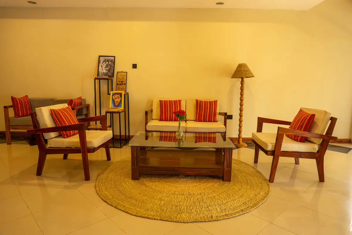 Suite lounge with armchairs and sofa at Mvuli Farm Lodge